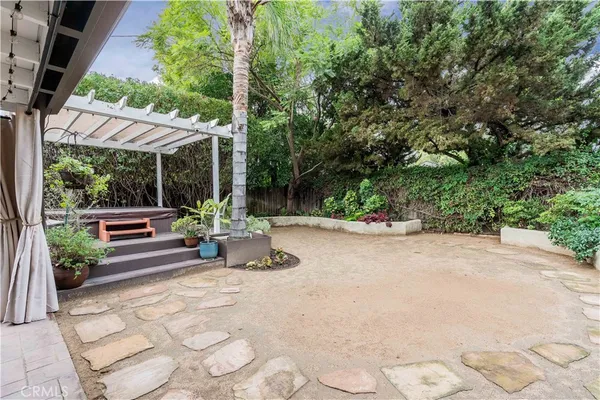 a view of a patio with table and chairs potted plants with floor to ceiling window and potted plants