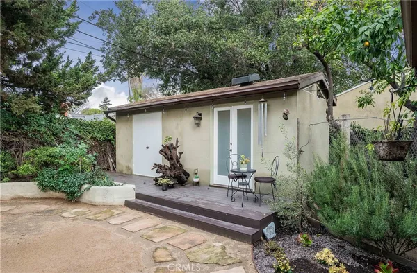 a view of a backyard with sitting area