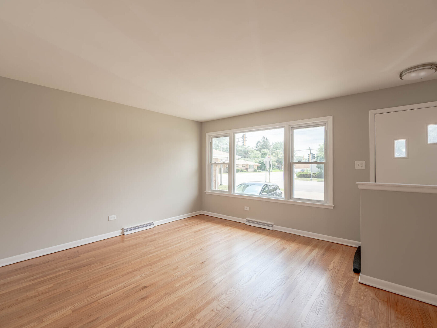 2304 Oakton Street Park Ridge, IL 60068 - Photo 2 of 14 an empty room with wooden floor and windows