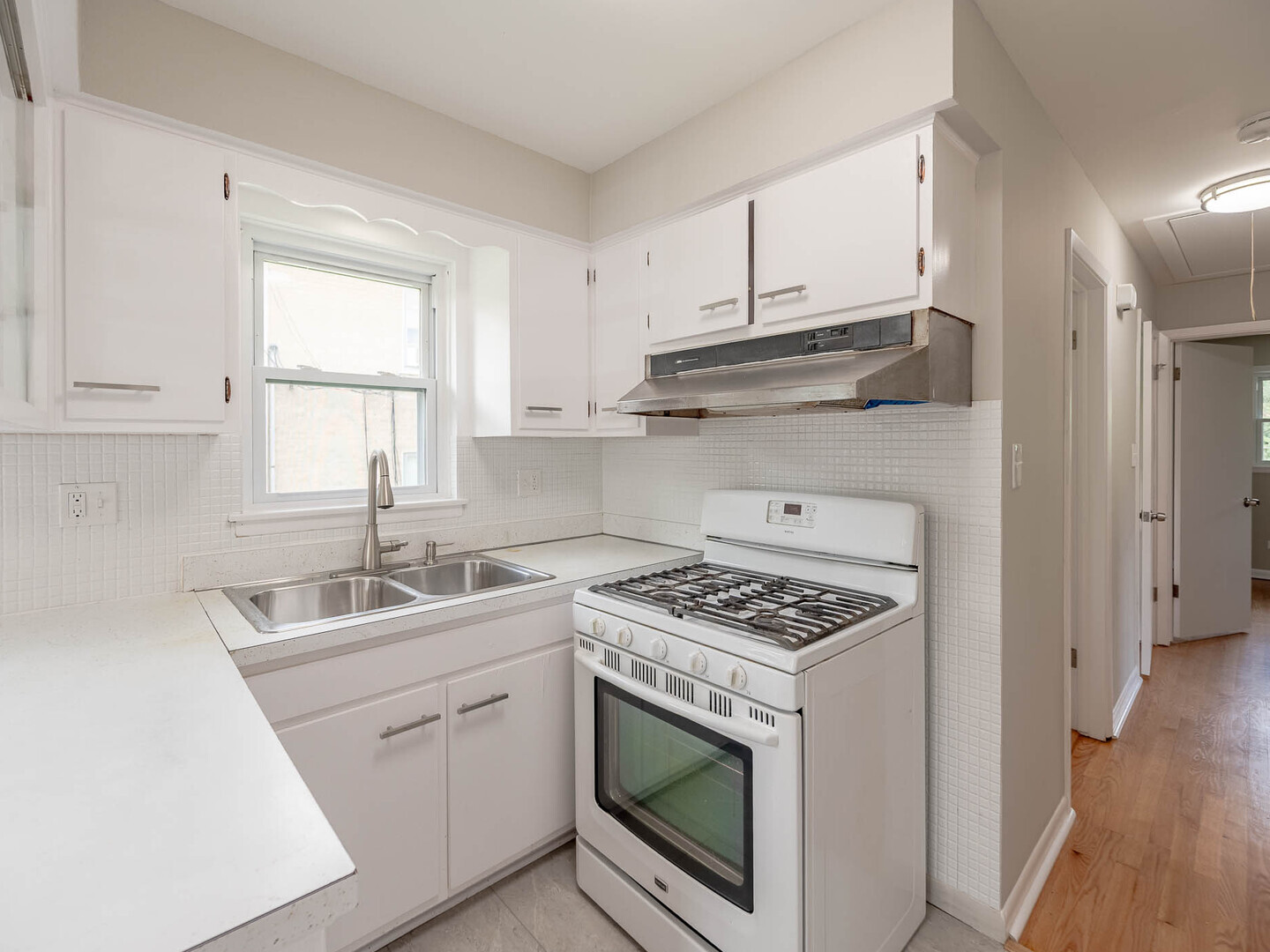 2304 Oakton Street Park Ridge, IL 60068 - Photo 5 of 14 a kitchen with cabinets appliances a sink and a window