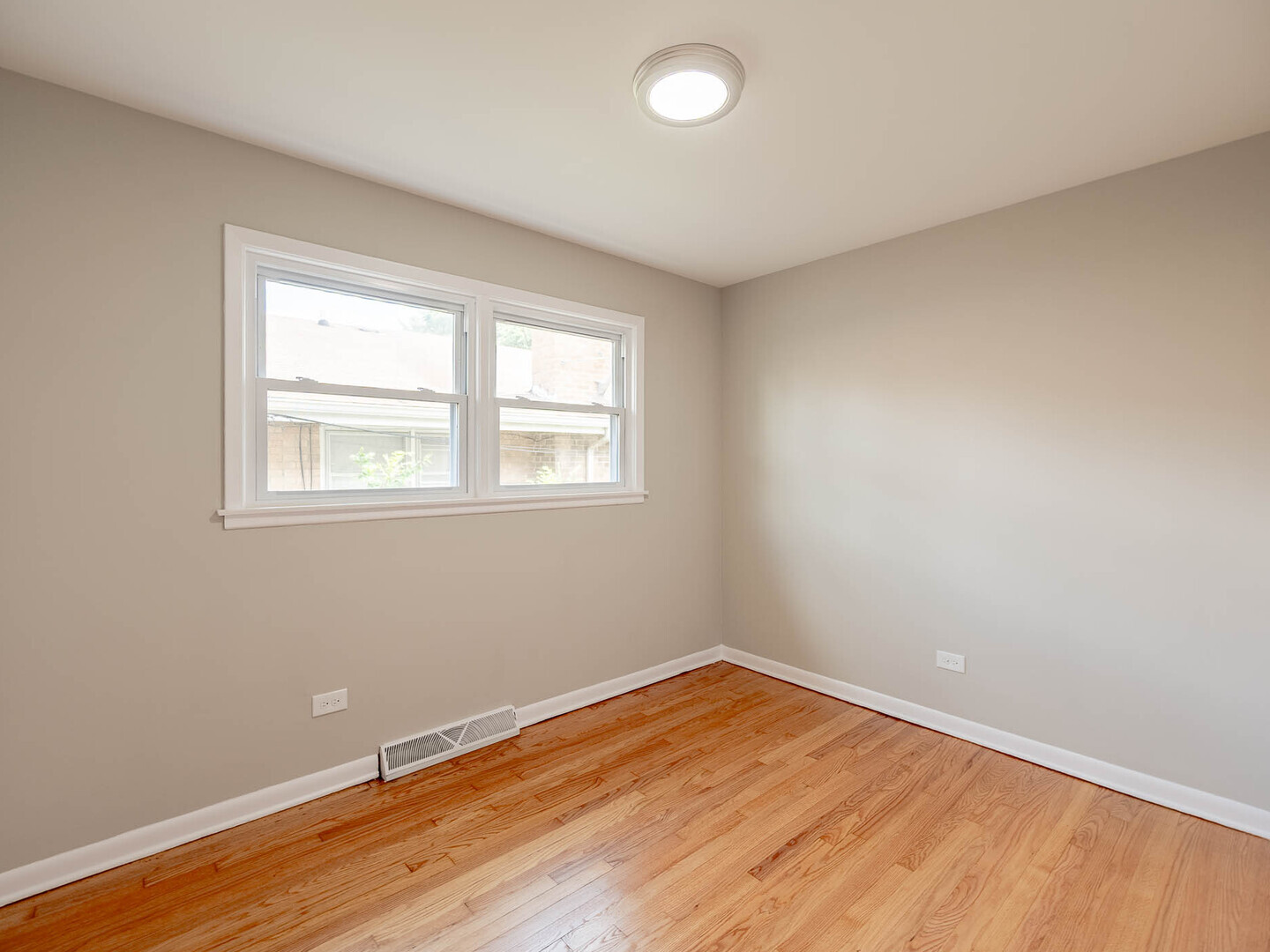 2304 Oakton Street Park Ridge, IL 60068 - Photo 7 of 14 an empty room with wooden floor and windows