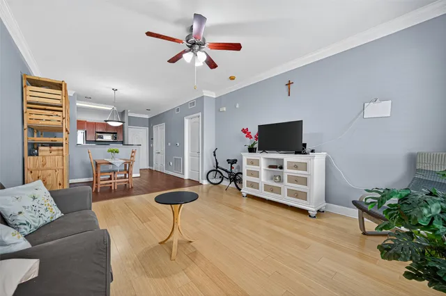 a living room with furniture and a wooden floor