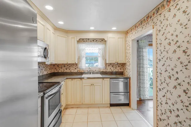 a kitchen with stainless steel appliances granite countertop a stove and a sink