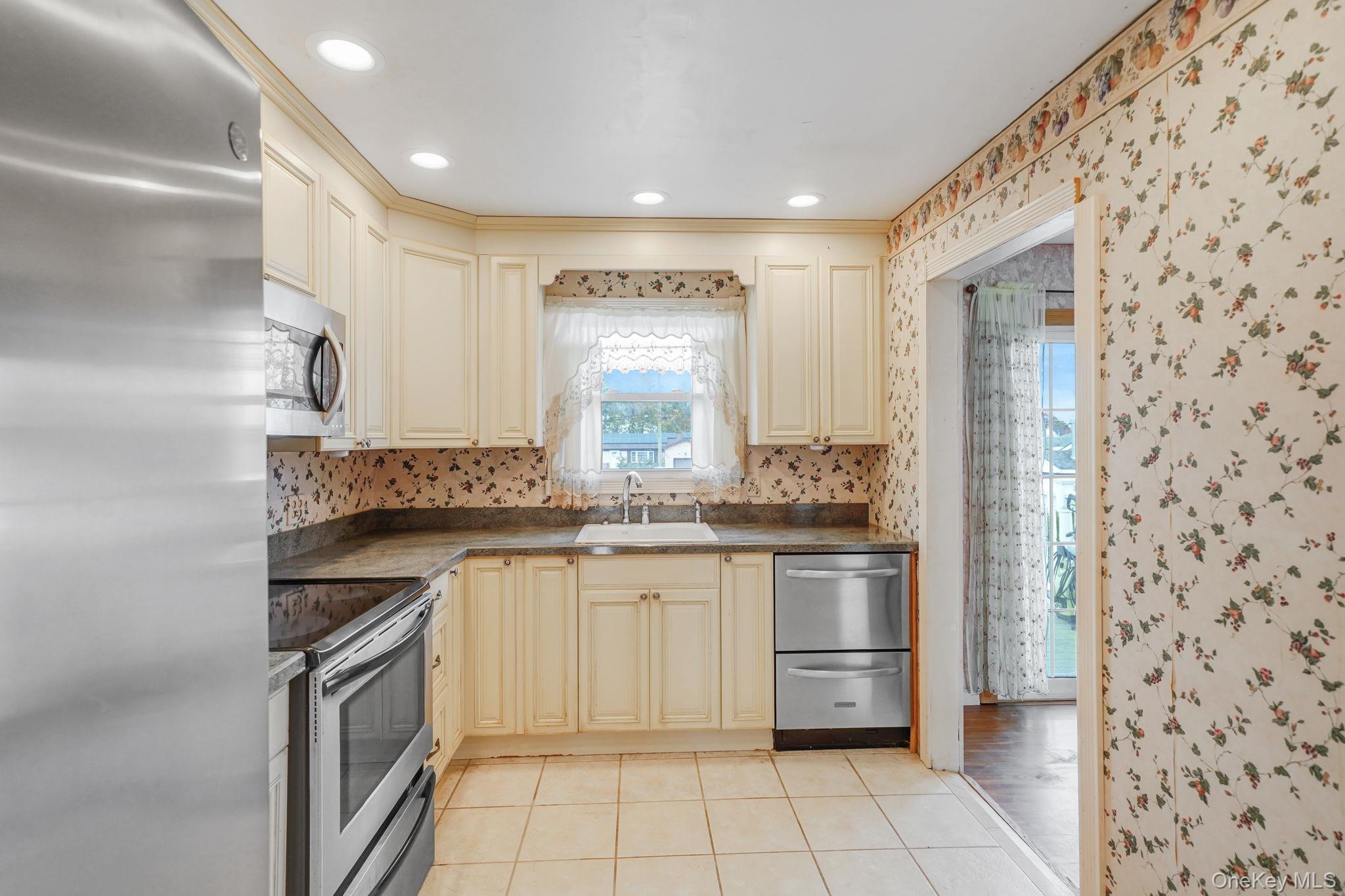 501 Windmill Avenue West Babylon, NY 11704 - Photo 15 of 35 a kitchen with stainless steel appliances granite countertop a stove and a sink