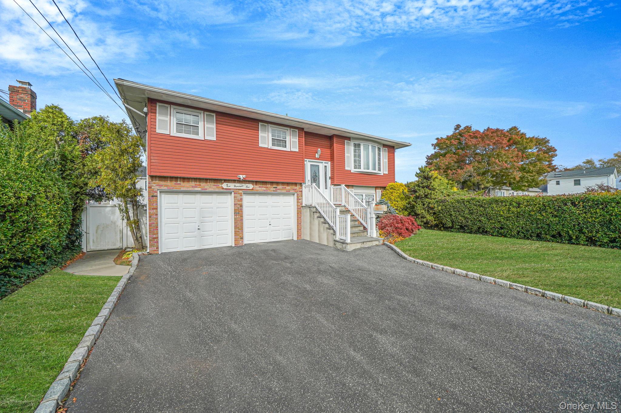 501 Windmill Avenue West Babylon, NY 11704 - Photo 2 of 35 a front view of a house with a yard and garage