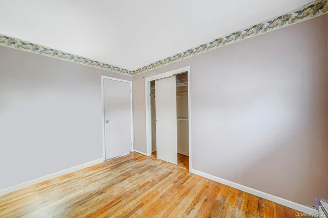 a view of a room with wooden floor
