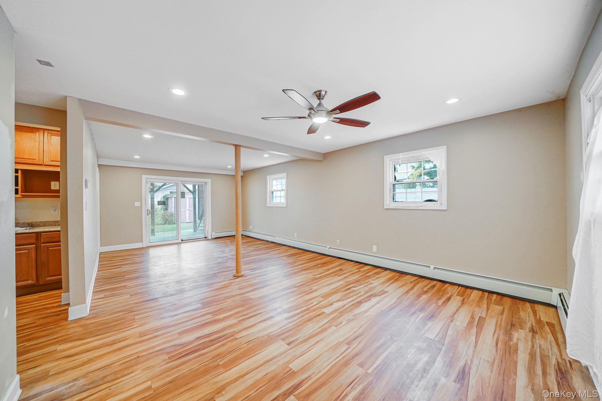 501 Windmill Avenue West Babylon, NY 11704 - Photo 25 of 35 a view of an empty room with wooden floor and a window