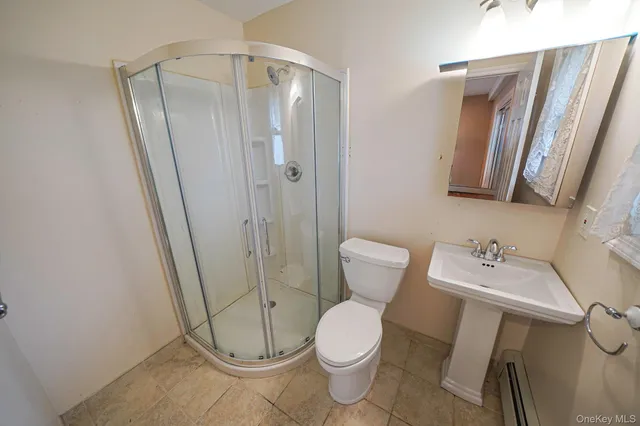 a white toilet sitting next to a bathroom sink