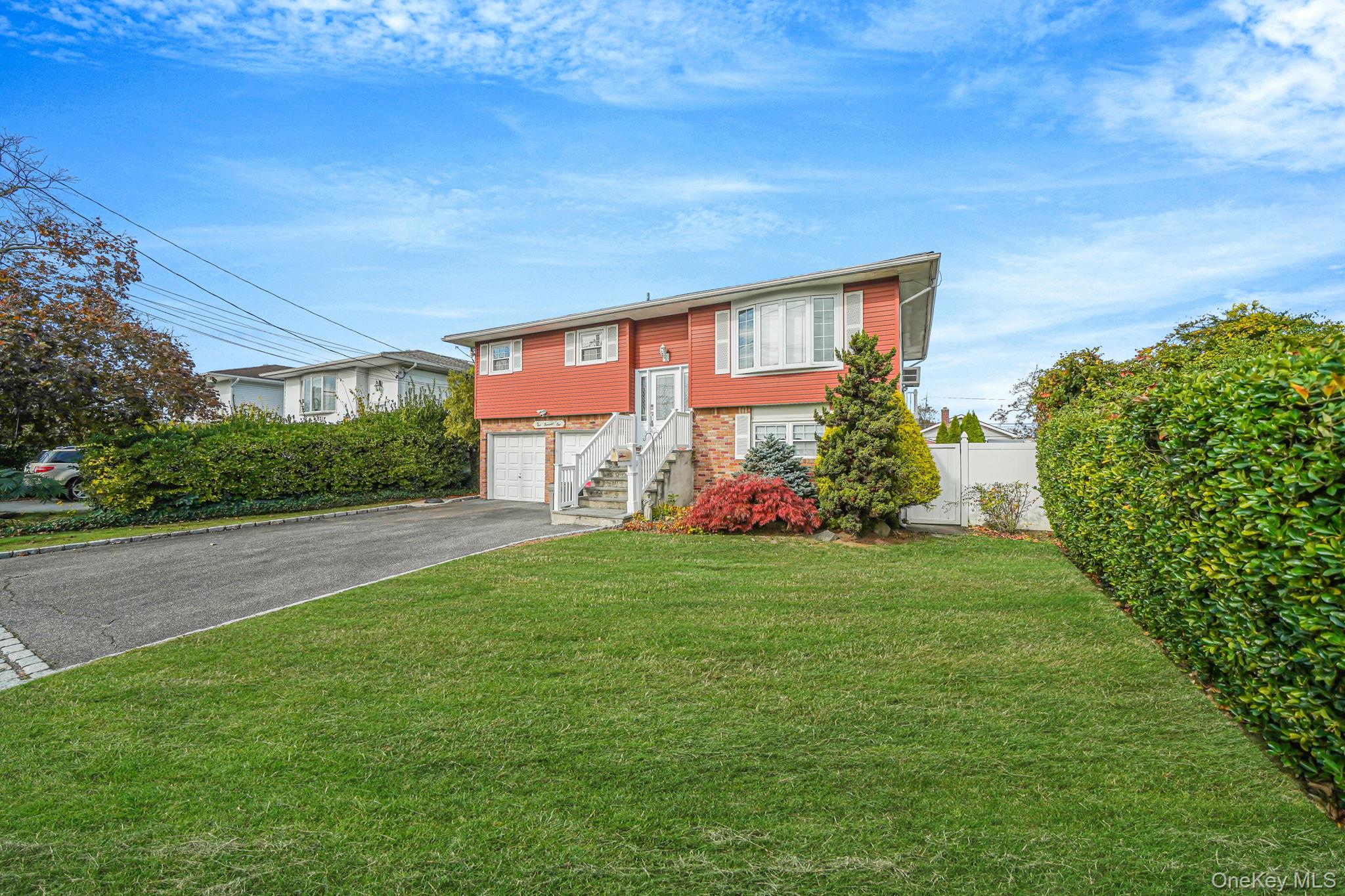 501 Windmill Avenue West Babylon, NY 11704 - Photo 3 of 35 a front view of a house with garden