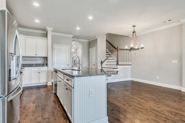 a kitchen with stainless steel appliances a stove top oven a refrigerator a sink and dishwasher