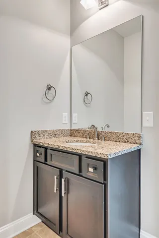 a utility room with a sink and a mirror