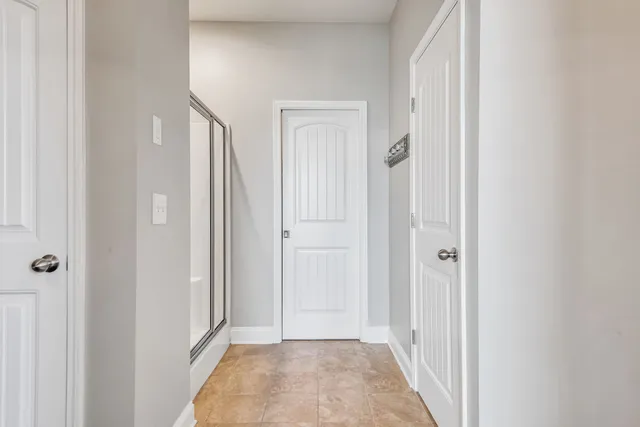 a view of a hallway with a bathroom