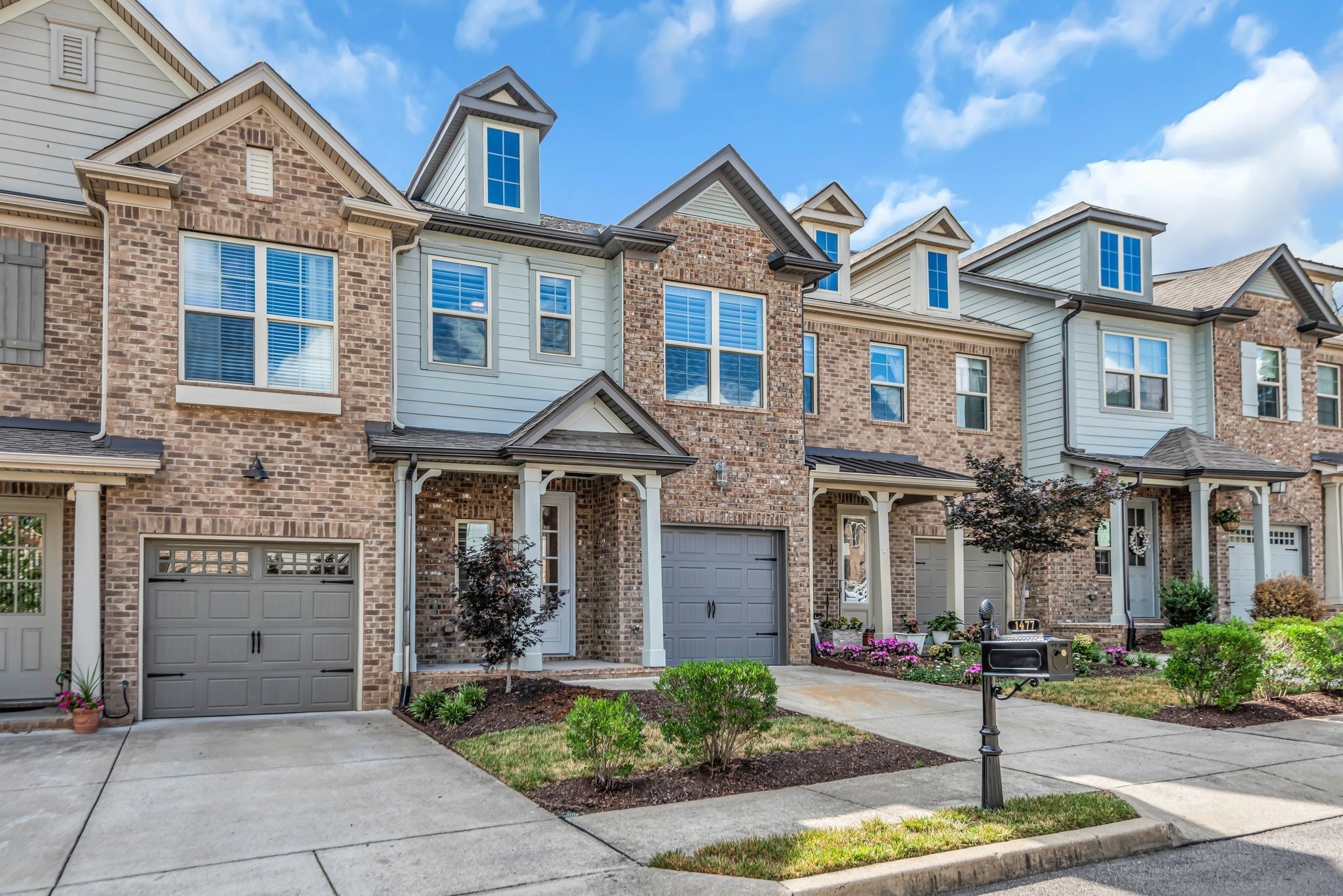 1477 Channing Drive Thompson's Station, TN 37179 - Photo 3 of 33 a front view of a house with garage and plants