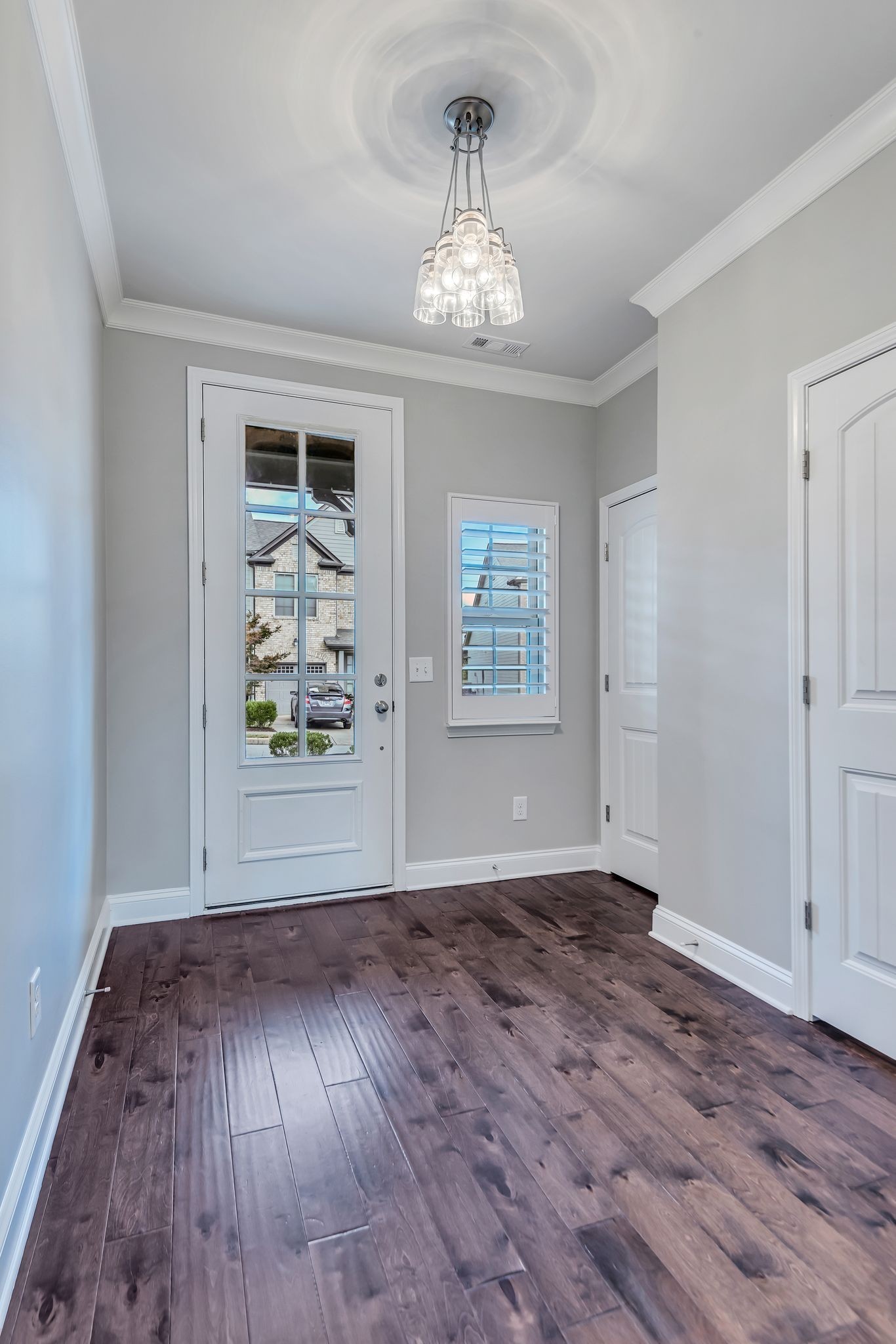 1477 Channing Drive Thompson's Station, TN 37179 - Photo 6 of 33 an empty room with wooden floor chandelier and windows
