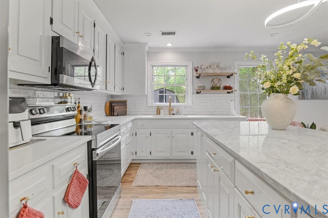 9820 Beaver Bridge Road Chesterfield, VA 23838 - Photo 15 of 54 White kitchen featuring a large island, white cabi
