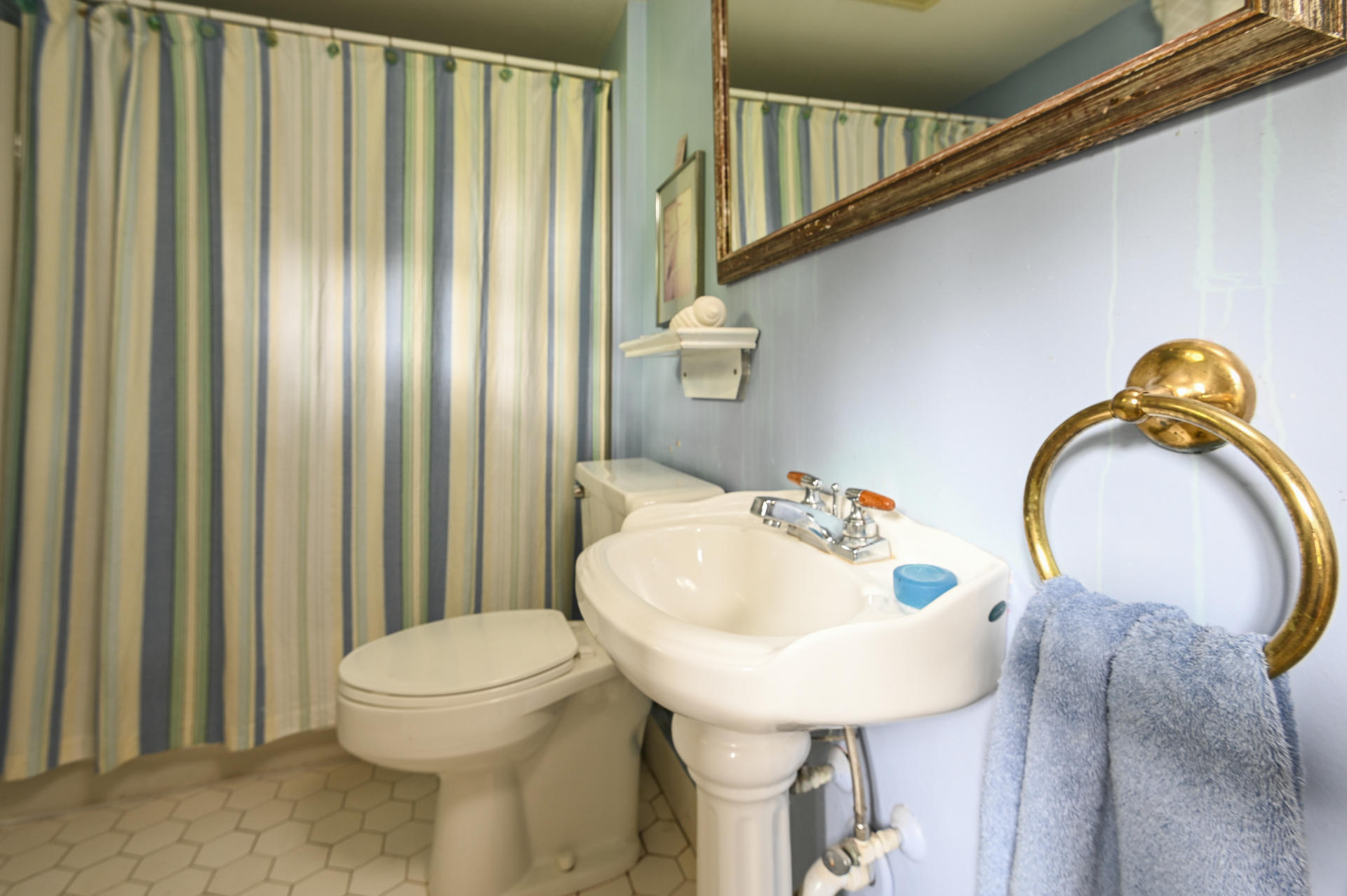 56 Depot Road Harwich, MA 02671 - Photo 8 of 25 a bathroom with a sink a toilet and shower curtain
