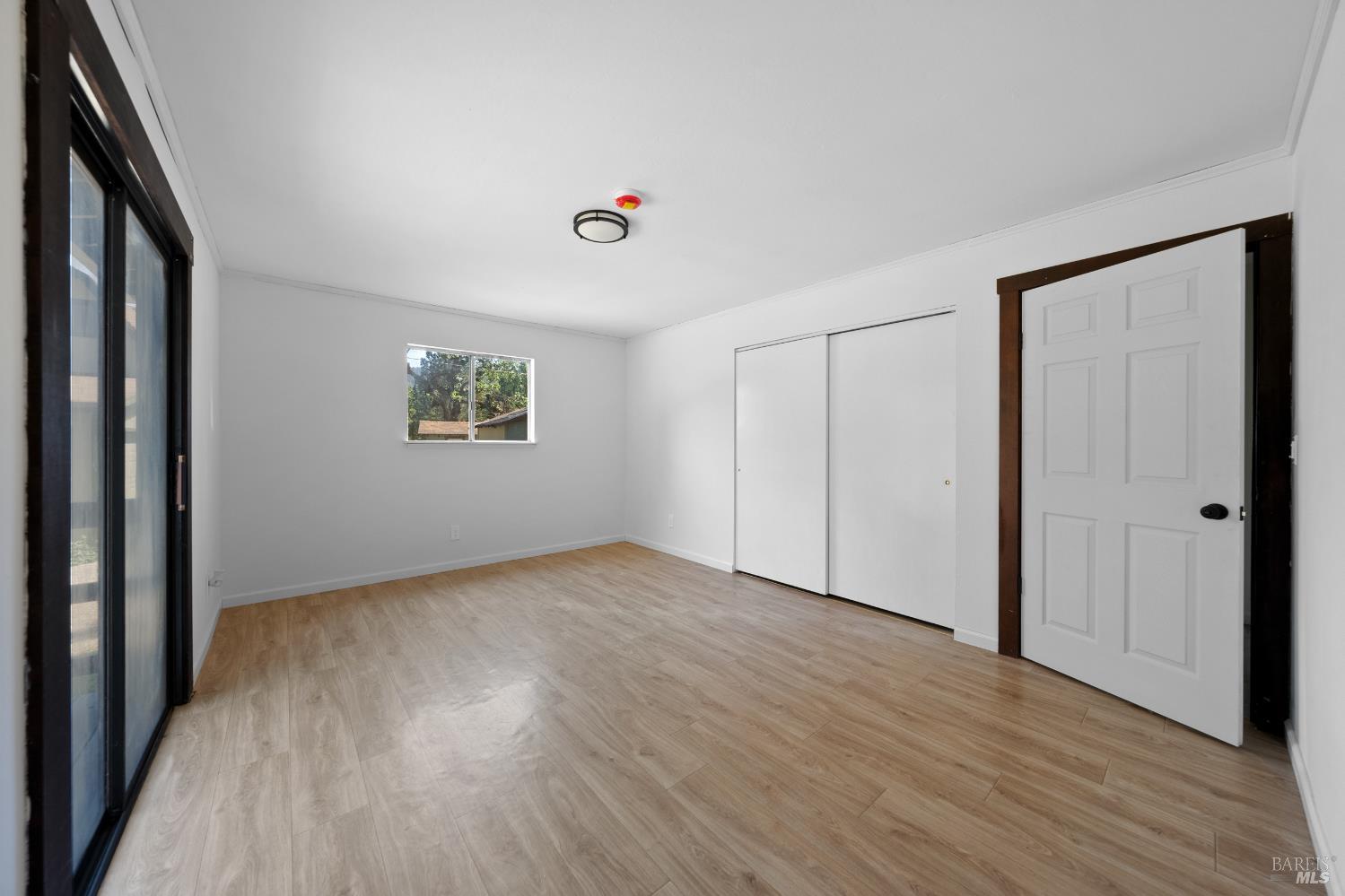17651 Van Arsdale Road Potter Valley, CA 95469 - Photo 65 of 92 a view of an empty room with wooden floor and a window
