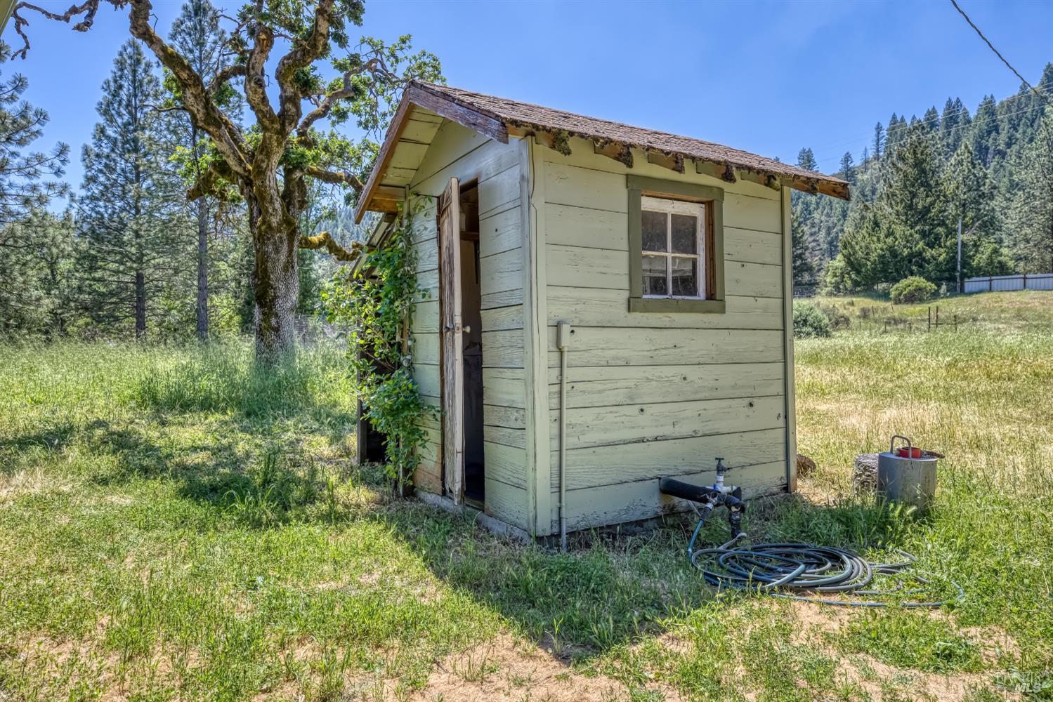 17651 Van Arsdale Road Potter Valley, CA 95469 - Photo 77 of 92 a view of a wooden house with a yard