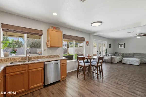 a kitchen with a table chairs stove and cabinets