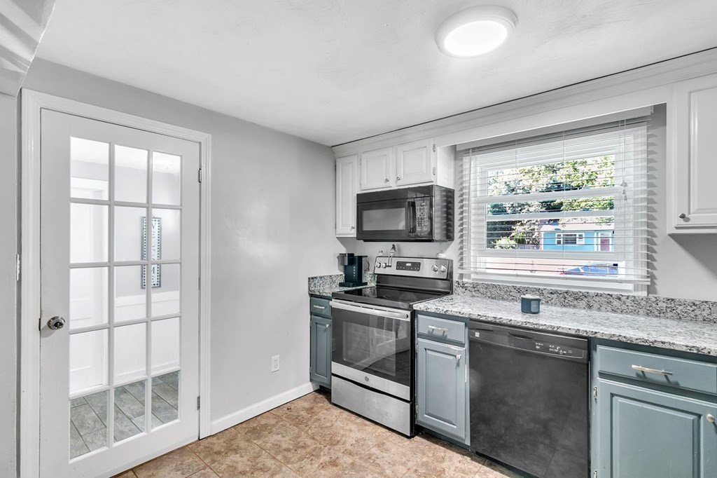 140 Talbot Road Springfield, MA 01119 - Photo 12 of 41 a kitchen with stainless steel appliances granite countertop a stove a sink and a microwave