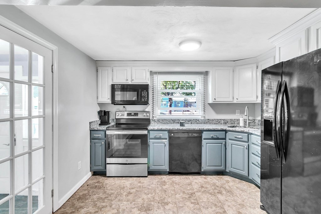 140 Talbot Road Springfield, MA 01119 - Photo 13 of 41 a kitchen with stainless steel appliances granite countertop a stove top oven a sink dishwasher a refrigerator and a microwave