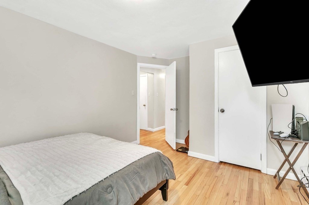 140 Talbot Road Springfield, MA 01119 - Photo 27 of 41 a bedroom with a bed and wooden floor