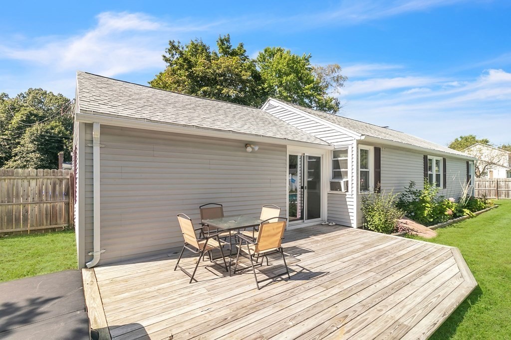 140 Talbot Road Springfield, MA 01119 - Photo 33 of 41 a view of a patio with table and chairs with wooden floor and fence
