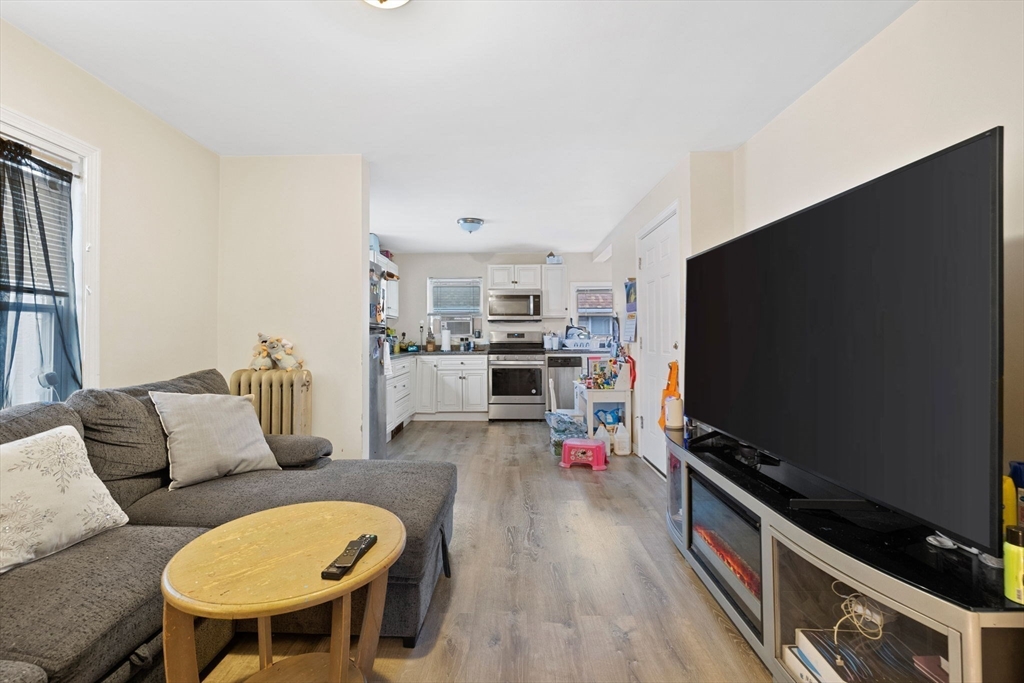 19 Alfred Street, Unit 2 Everett, MA 02149 - Photo 2 of 14 a living room with furniture and a flat screen tv