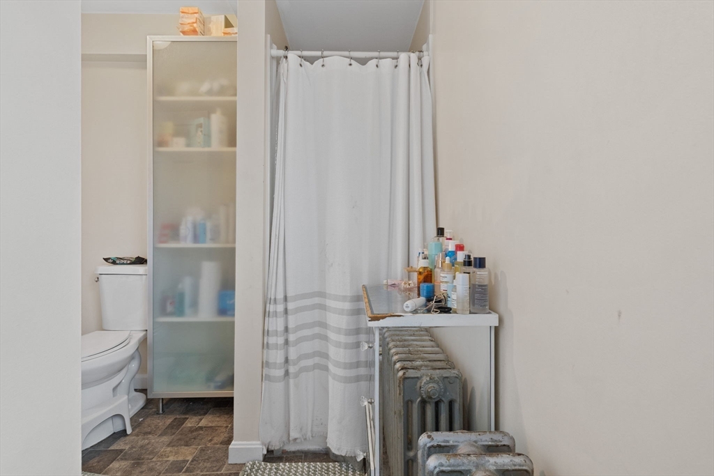 19 Alfred Street, Unit 2 Everett, MA 02149 - Photo 10 of 14 a bathroom with a sink a toilet and shower