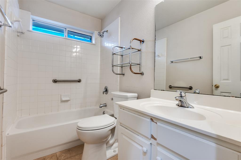 8530 Quicksilver Drive Dallas, TX 75249 - Photo 13 of 25 a bathroom with a sink a toilet and shower