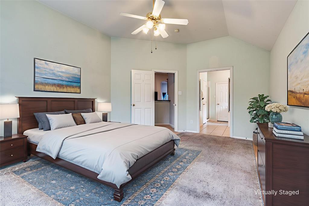 8530 Quicksilver Drive Dallas, TX 75249 - Photo 15 of 25 a bedroom with bed and a chandelier