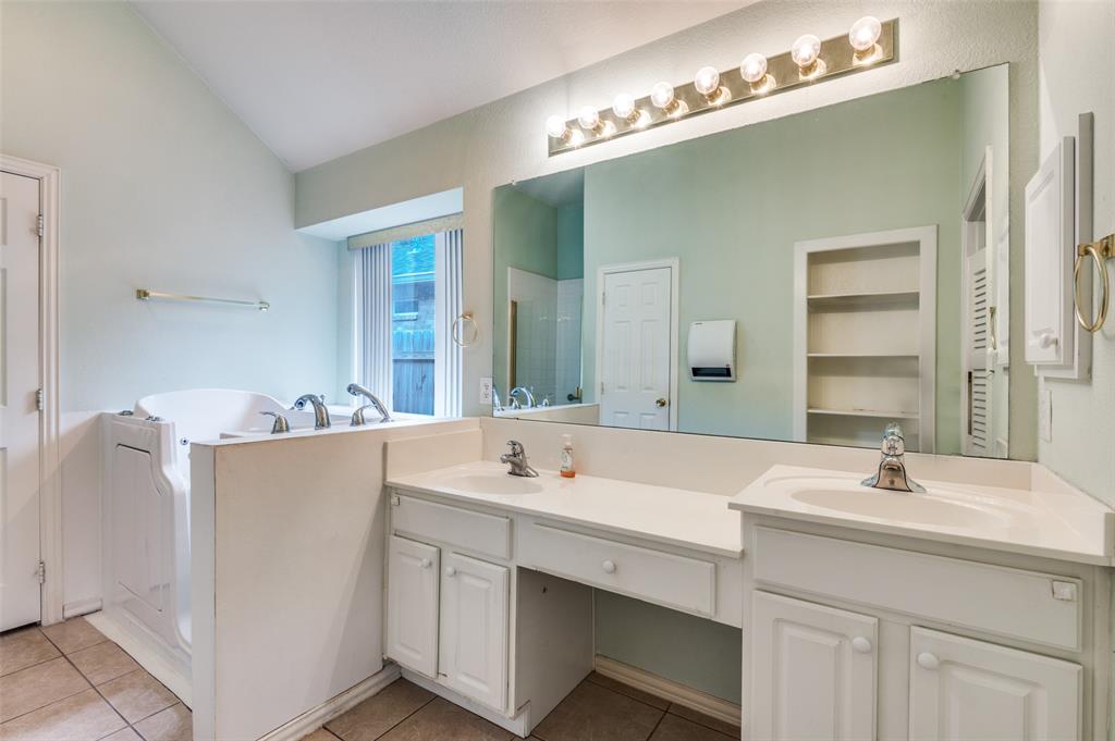 8530 Quicksilver Drive Dallas, TX 75249 - Photo 16 of 25 a bathroom with a double vanity sink mirror and