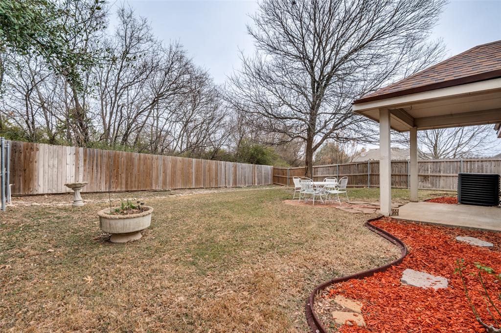 8530 Quicksilver Drive Dallas, TX 75249 - Photo 20 of 25 a backyard of a house with table and chairs