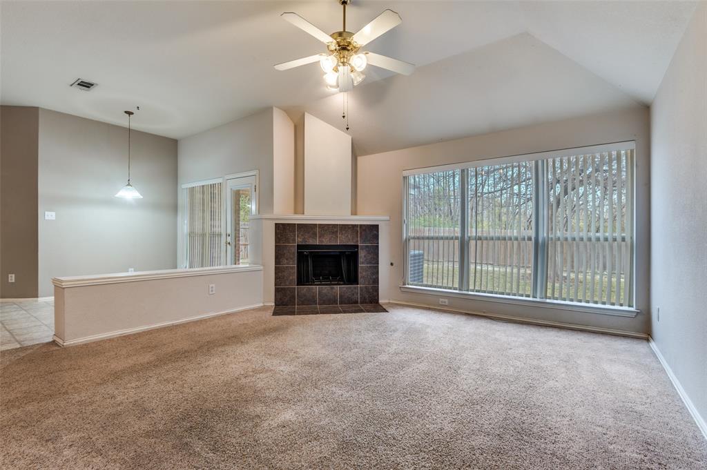 8530 Quicksilver Drive Dallas, TX 75249 - Photo 2 of 25 a view of an empty room with a fireplace and a window