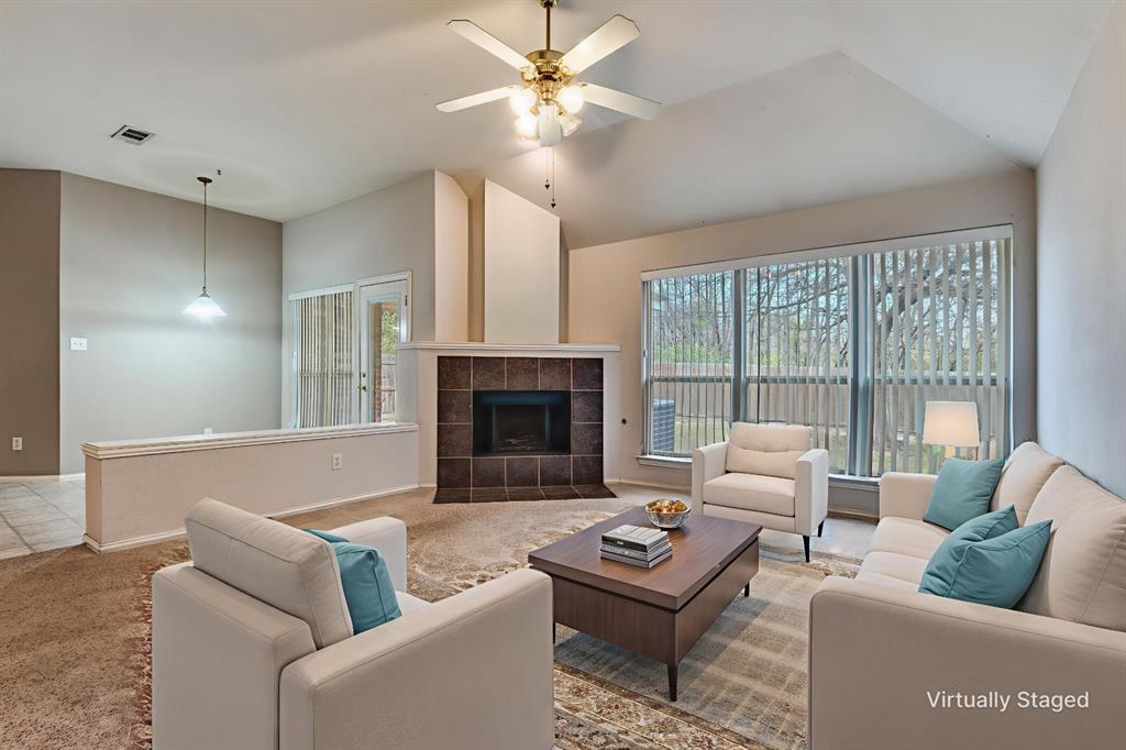 8530 Quicksilver Drive Dallas, TX 75249 - Photo 3 of 25 a living room with furniture and a fireplace