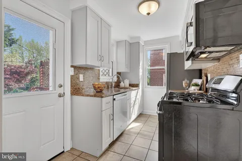 a kitchen with a stove a sink and a refrigerator