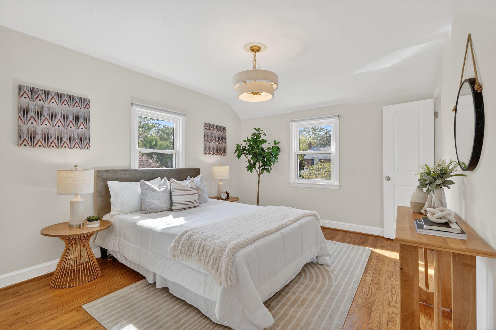 10015 Markham Street Silver Spring, MD 20901 - Photo 12 of 31 a bedroom with a large bed and a chandelier