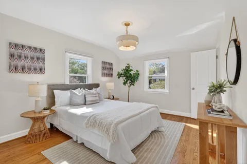 a bedroom with a large bed and a chandelier
