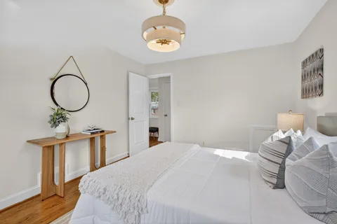 a bedroom with bed and a chandelier