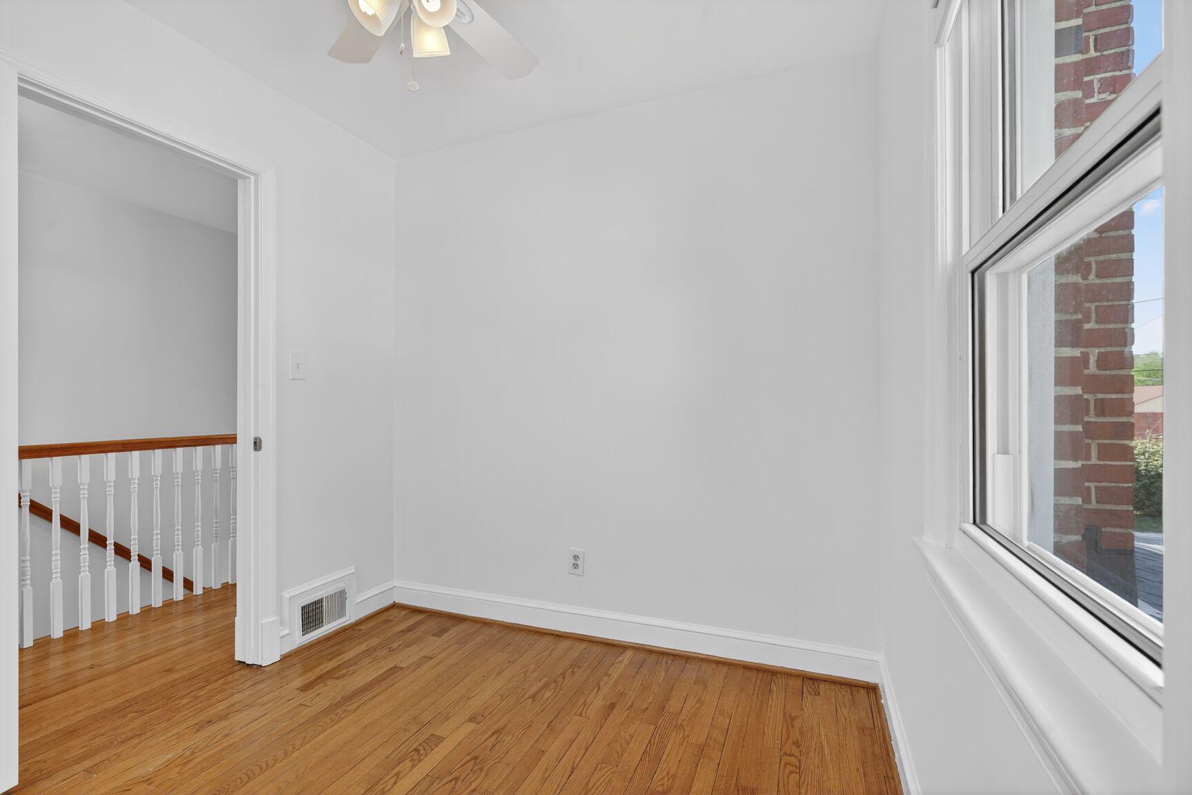 10015 Markham Street Silver Spring, MD 20901 - Photo 16 of 31 a view of an empty room with wooden floor and a window