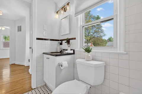 a bathroom with a toilet a sink and a mirror