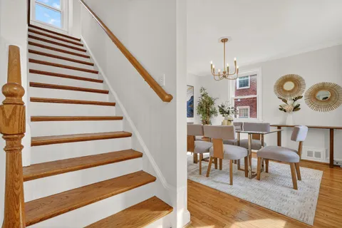 a view of entryway and hall with wooden floor