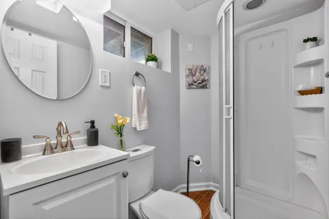 a bathroom with a toilet sink and mirror