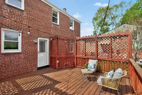a backyard of a house with table and chairs