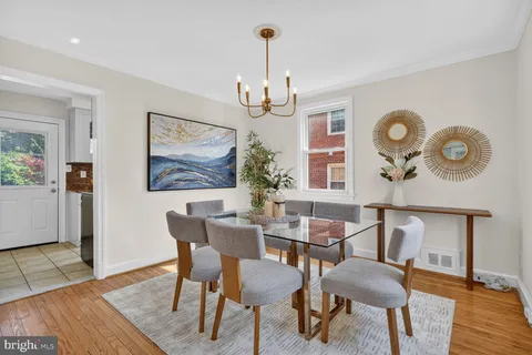 a view of a dining room with furniture wooden floor and a chandelier
