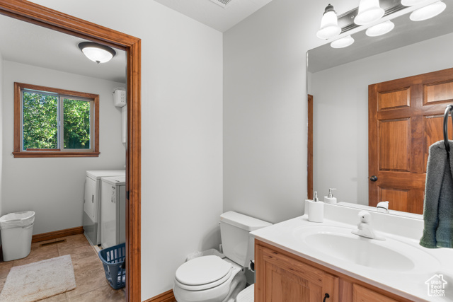 1340 Trapper Loop Garden City, UT 84028 - Photo 14 of 35 Bathroom featuring independent washer and dryer, vanity, and tile patterned flooring