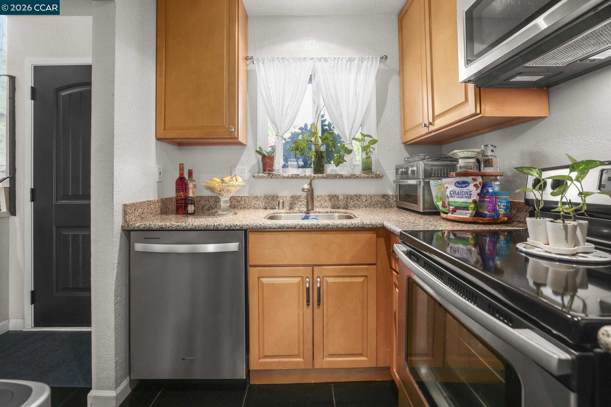 61 Meadowbrook Circle Pittsburg, CA 94565 - Photo 11 of 24 a kitchen with stainless steel appliances granite countertop a sink stove and cabinets