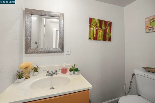 a bathroom with a sink mirror and toilet