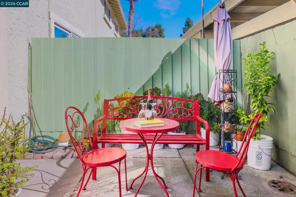 a view of a chairs and table in patio