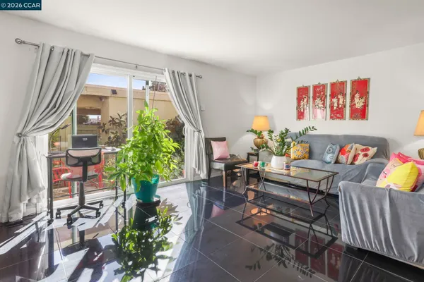 a living room with furniture and a potted plant